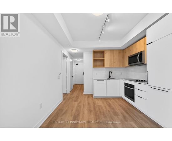 A kitchen with white cabinets and a wooden counter top.