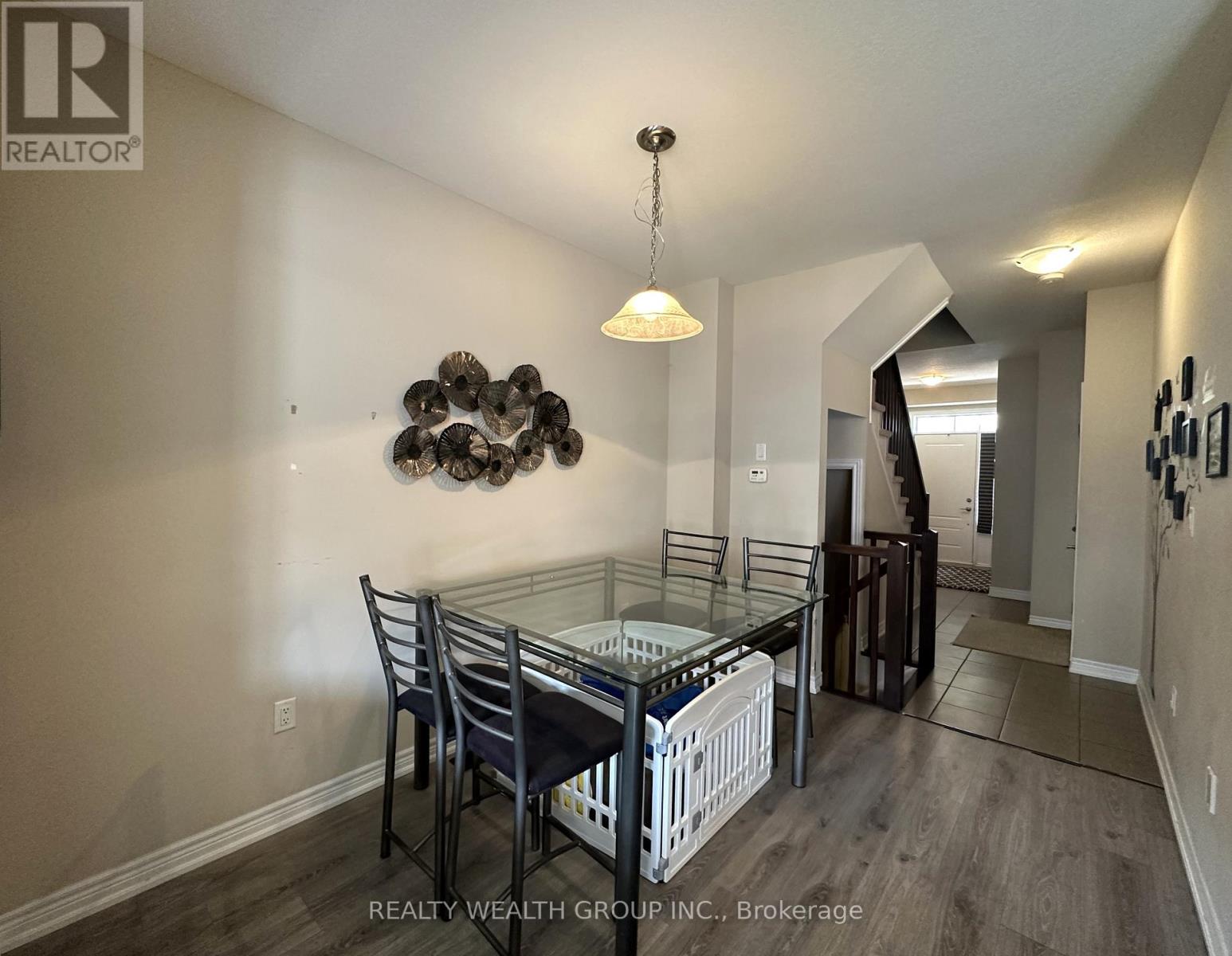 A dining room with a glass table and chairs.