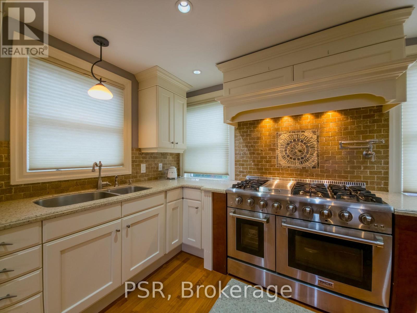 A kitchen with a stove top oven and a sink.