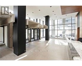 A modern interior space with a glass wall and a black column.