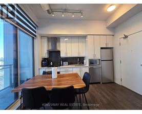 A kitchen with a table and chairs in front of a window.