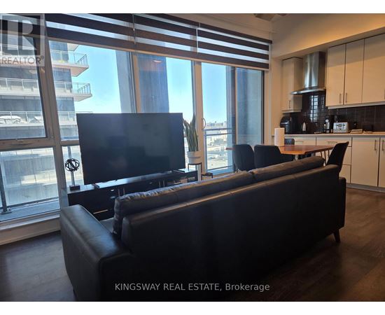 A living room with a couch and a television.