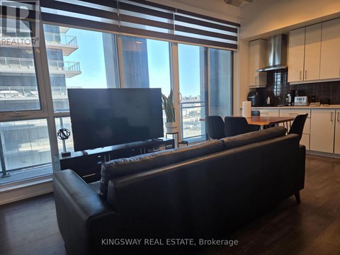 A living room with a couch and a television.