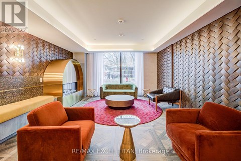 A living room with a red carpet and a patterned wallpaper.