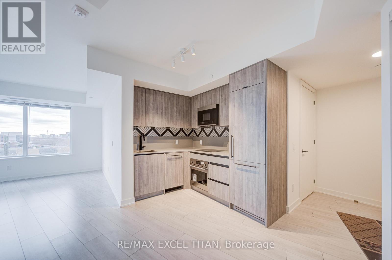 A spacious kitchen with wooden cabinets and a large island.