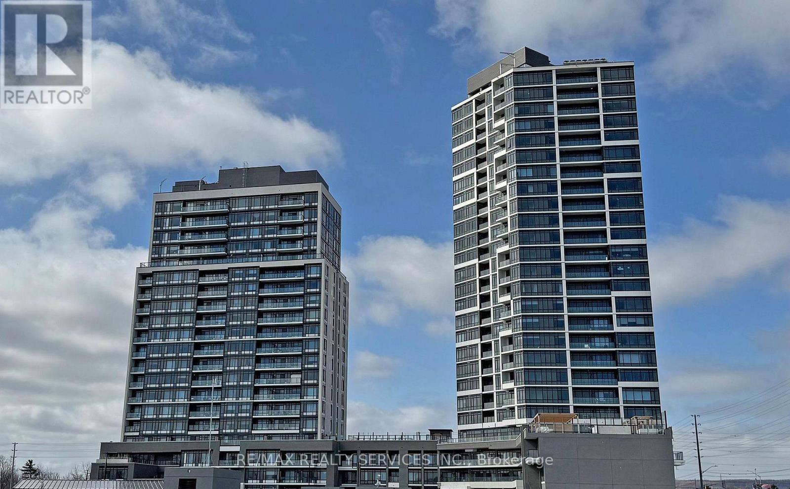 Two tall buildings with the words "REMAX REALTY SERVICES" on the front of the shorter one.