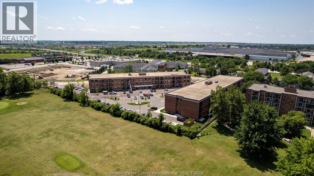 A bird's eye view of a large building complex surrounded by greenery.