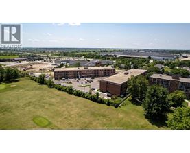 A bird's eye view of a large building complex surrounded by greenery.