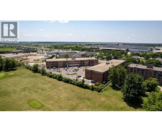 A bird's eye view of a large building complex surrounded by greenery.