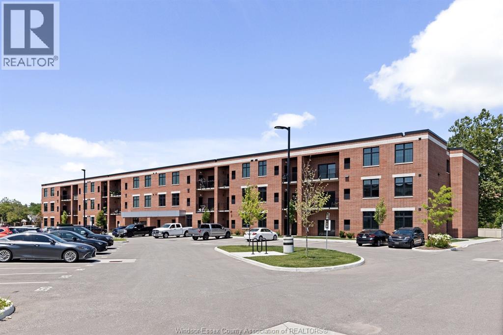 A parking lot in front of a multi-story brick building.