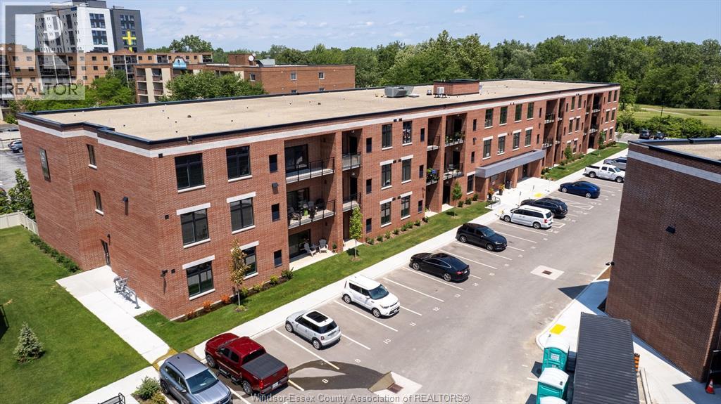 A parking lot in front of a red brick building.
