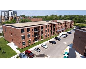 A parking lot in front of a red brick building.
