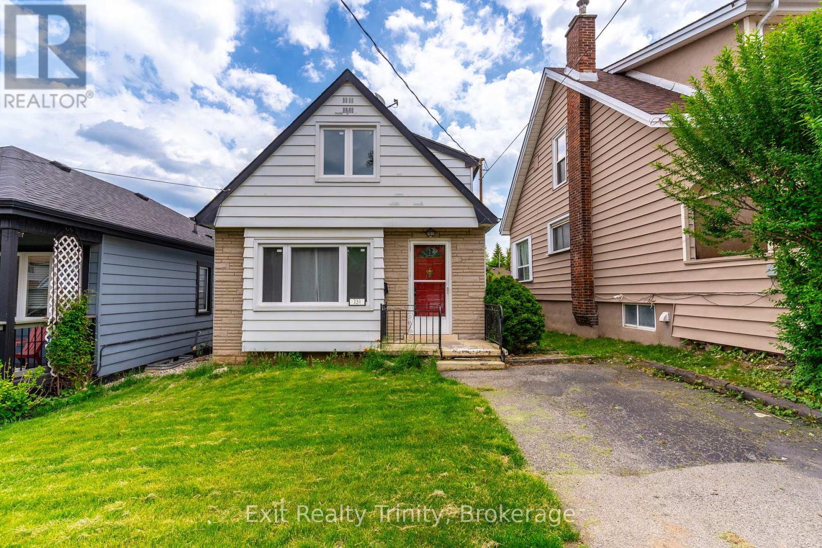 A house with a red door is for sale.