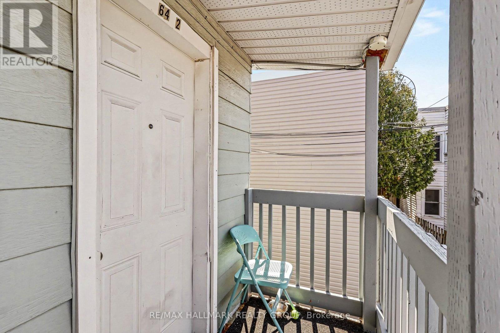 A small balcony with a chair and table.