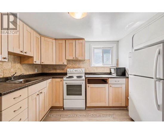 A kitchen with wooden cabinets and a white refrigerator.