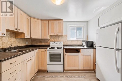 A kitchen with wooden cabinets and a white refrigerator.