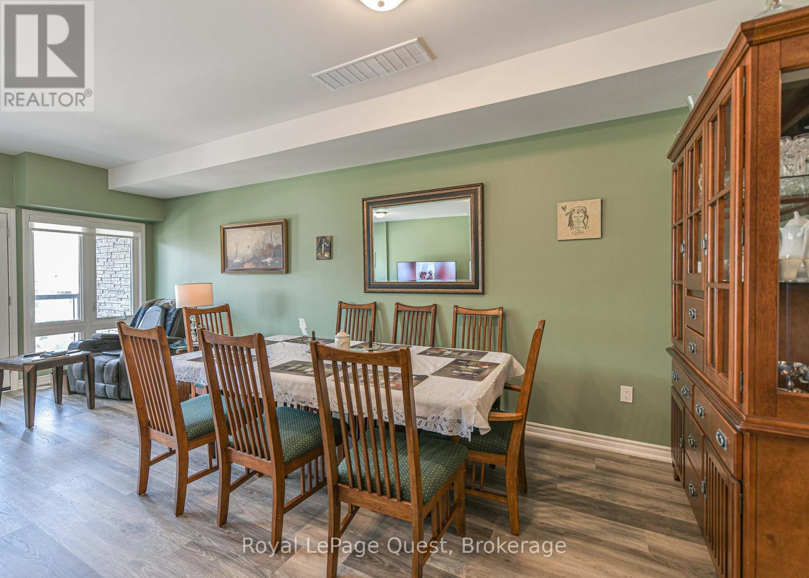 A dining room with a table set for six.