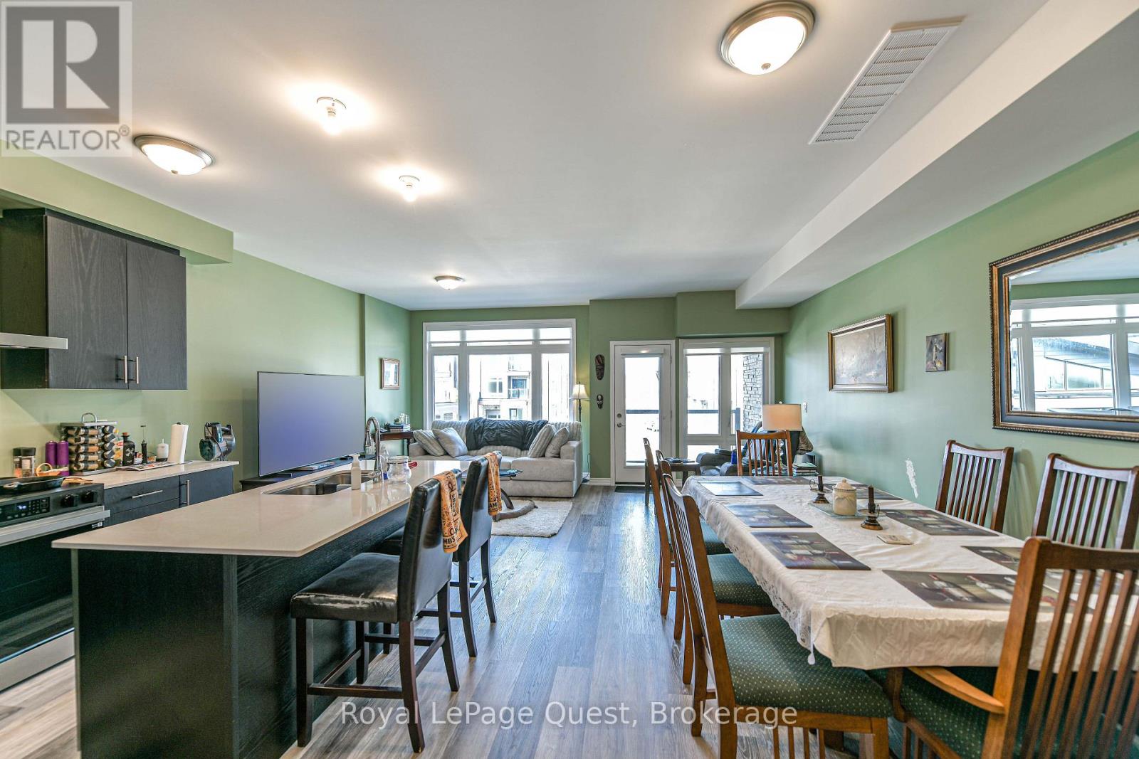 A well-lit kitchen and dining area with a table set for a meal.