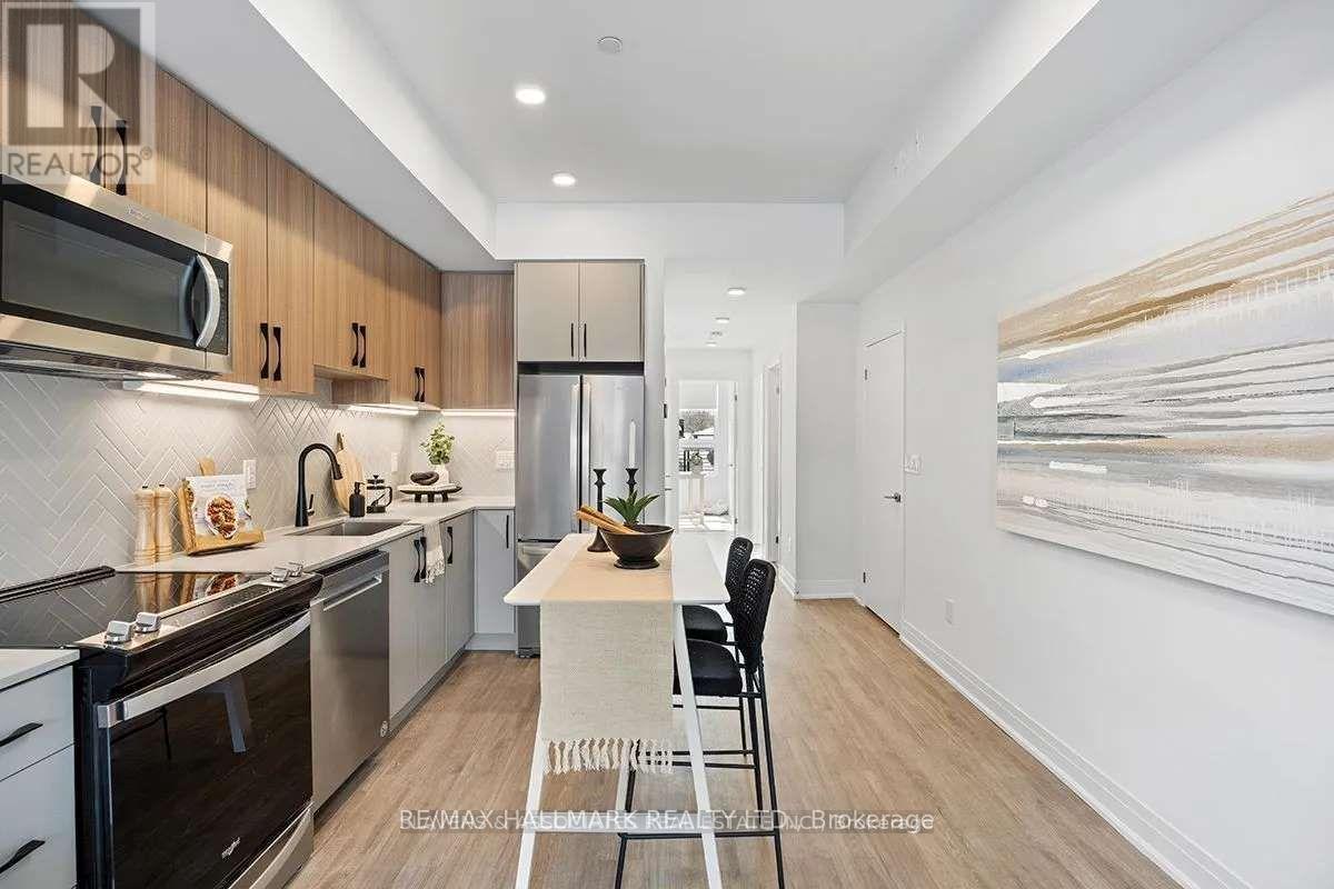 A modern kitchen with a dining table and chairs.