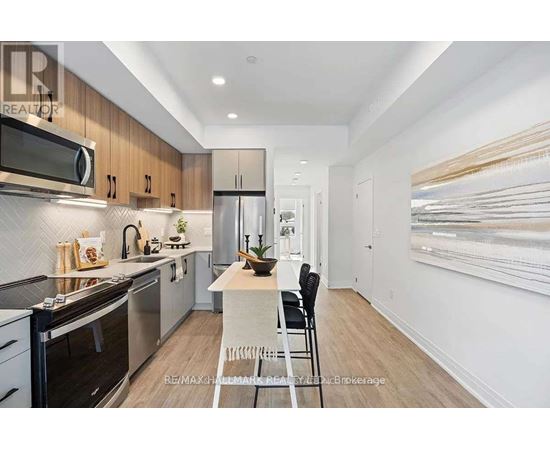 A modern kitchen with a dining table and chairs.