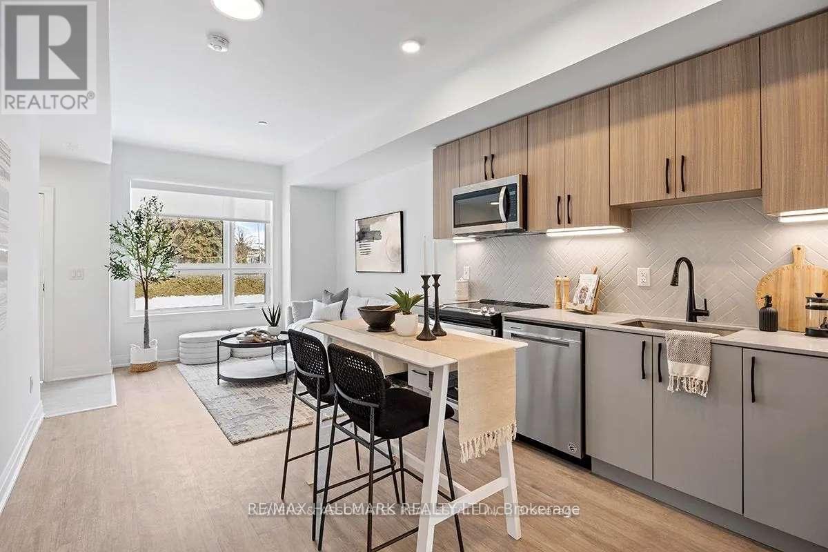 A modern kitchen with a dining table and chairs.