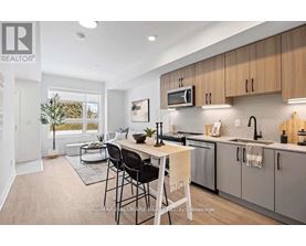 A modern kitchen with a dining table and chairs.