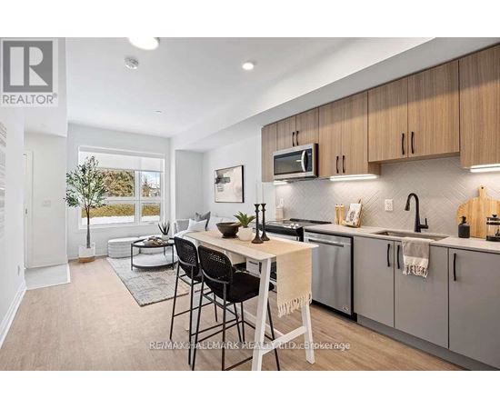 A modern kitchen with a dining table and chairs.