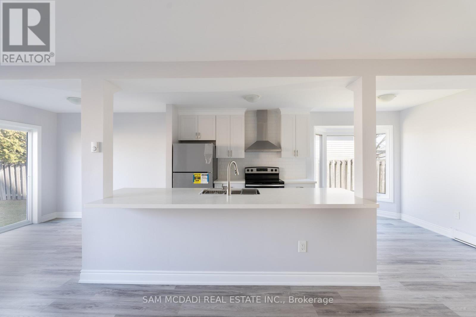 A kitchen area with white cabinets and a countertop.