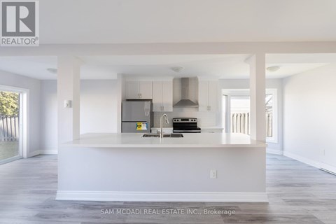 A kitchen area with white cabinets and a countertop.