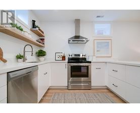 A modern kitchen with white cabinets and stainless steel appliances.
