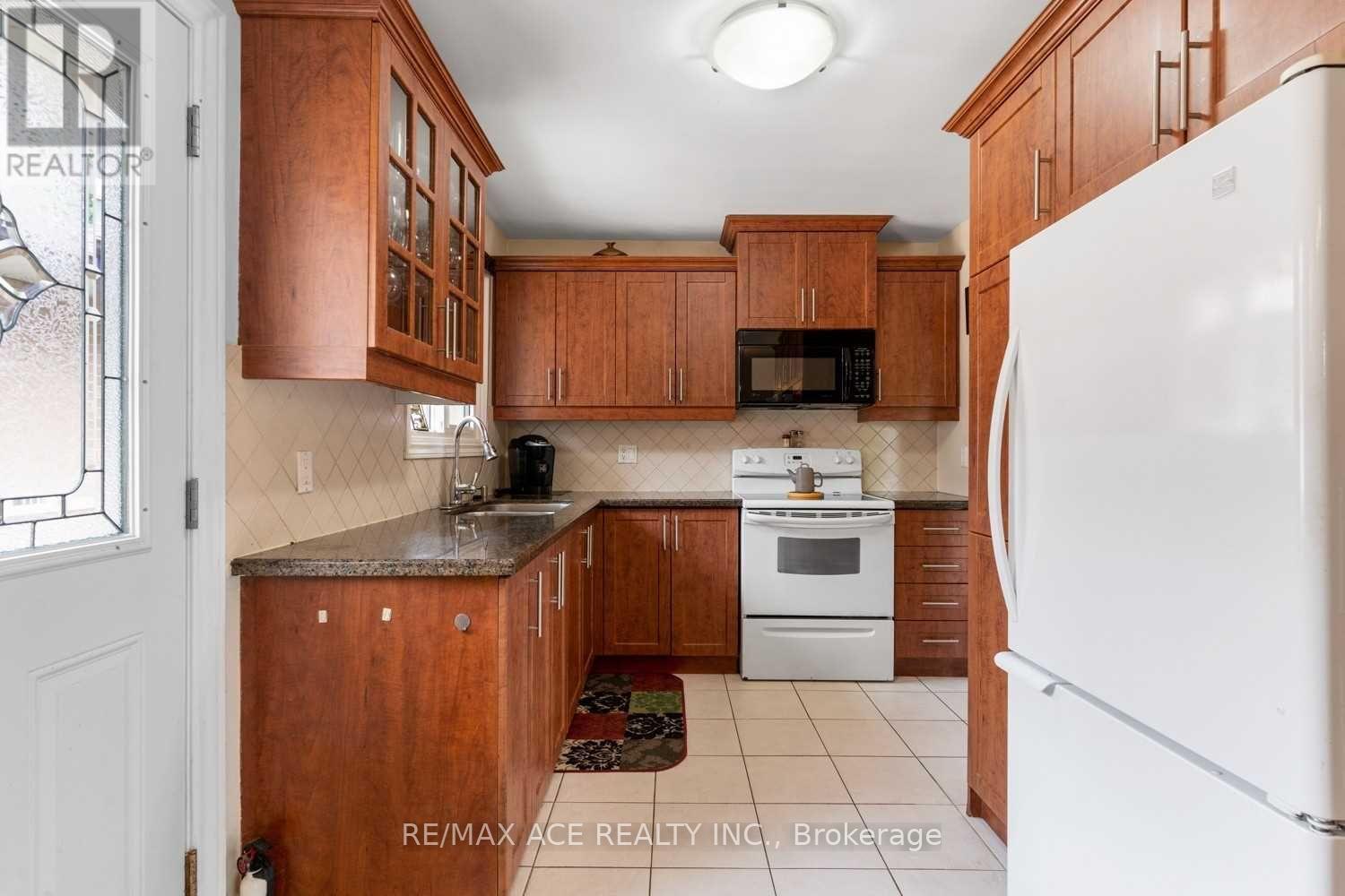 A kitchen with wooden cabinets and a white refrigerator.