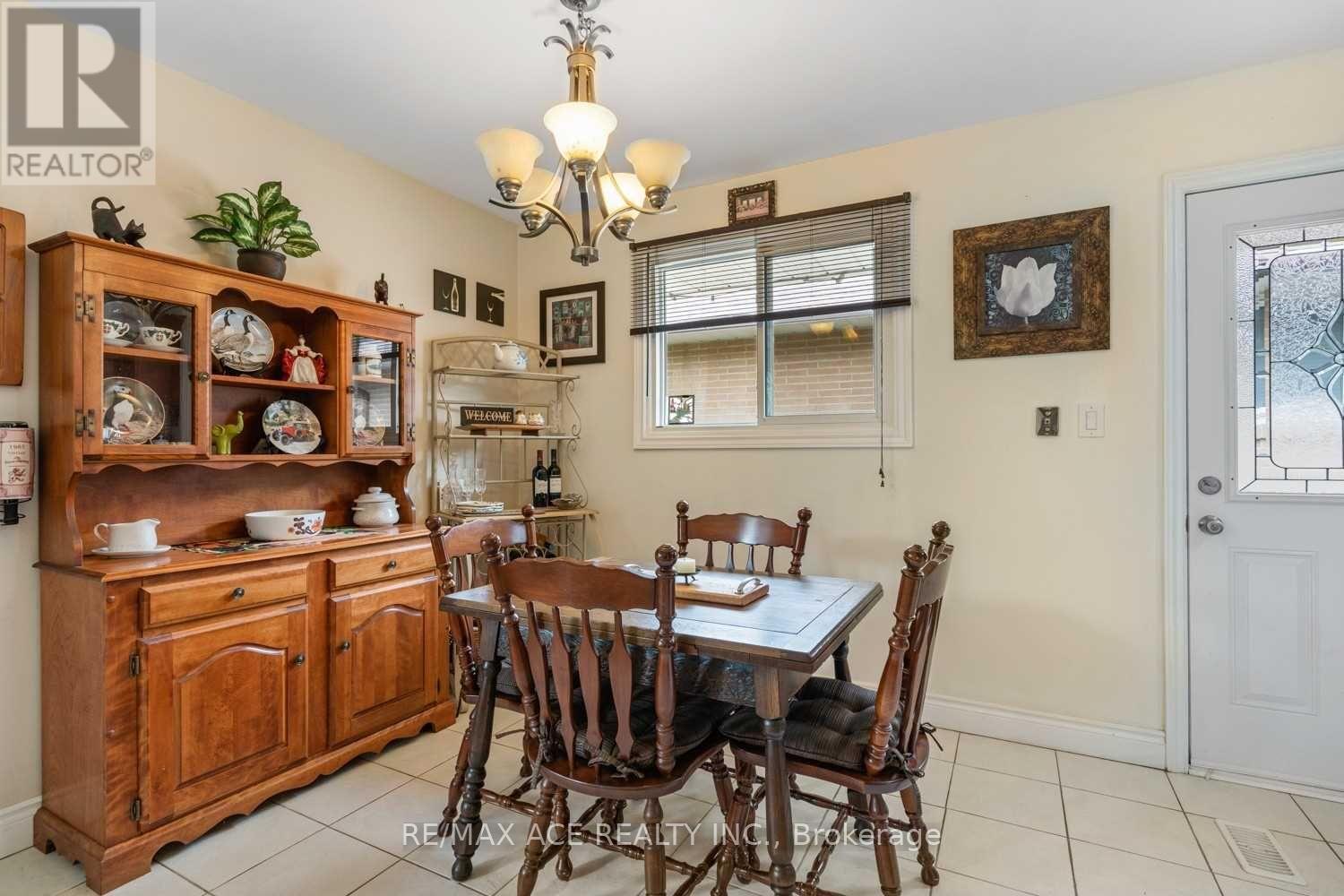 A dining room with a wooden table and chairs.