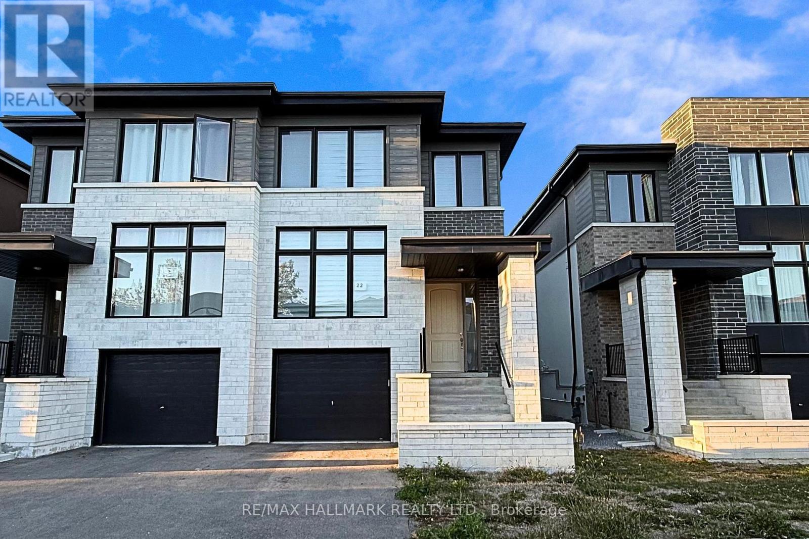 A modern two-story house with a garage is for sale.