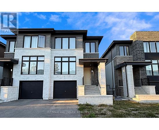 A modern two-story house with a garage is for sale.