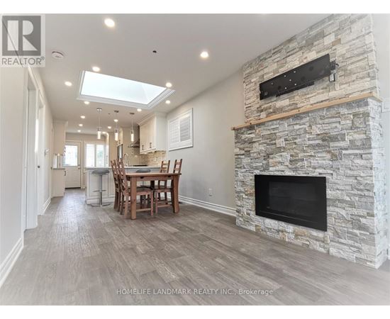 A stone fireplace is built into a wall in a spacious room.