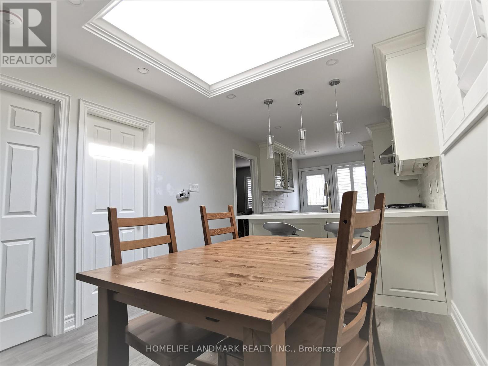A dining room with a wooden table and chairs.