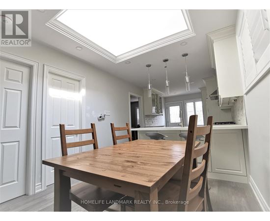 A dining room with a wooden table and chairs.