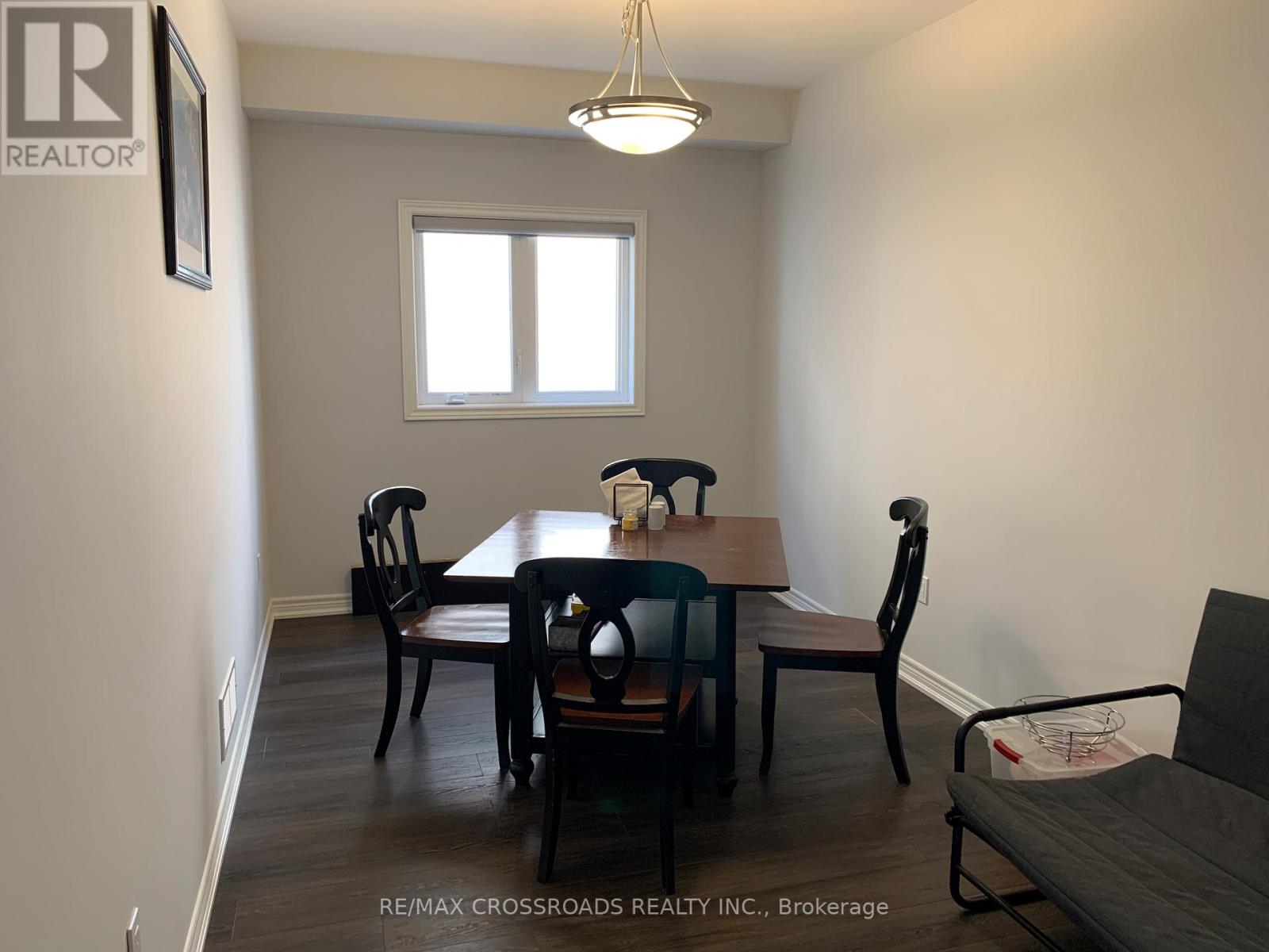 A dining room with a table and chairs.