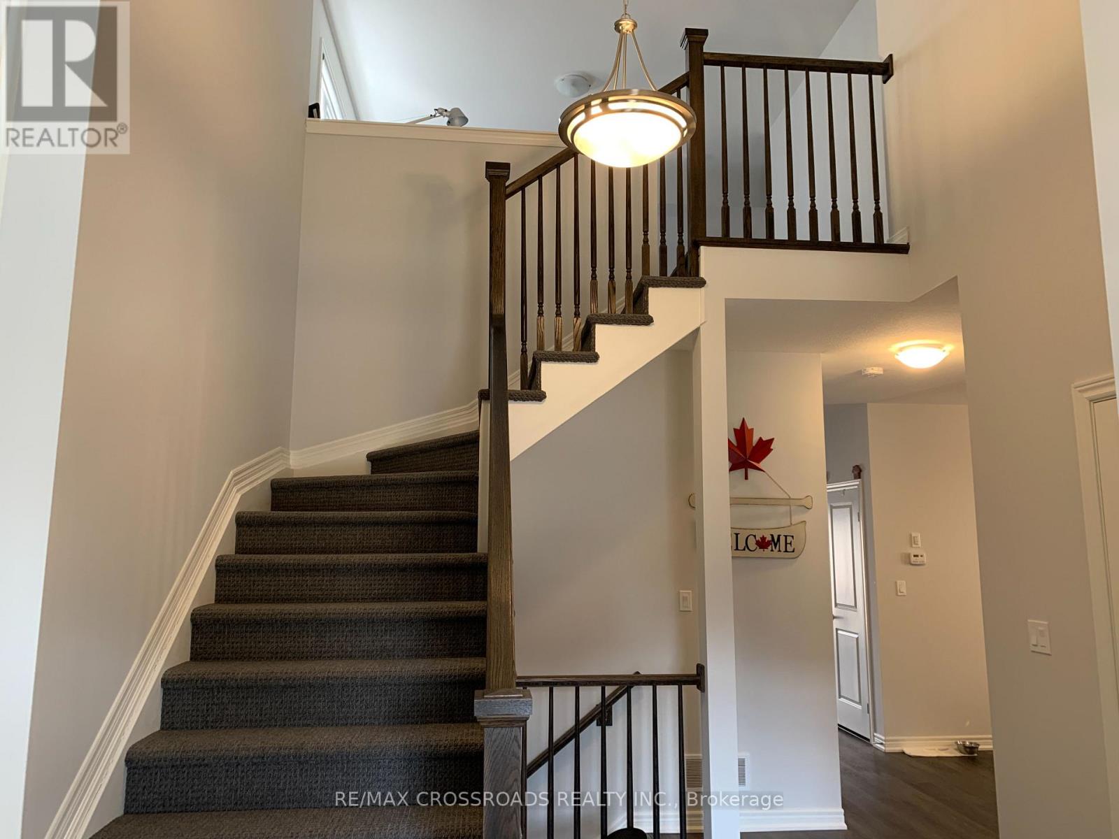 A staircase with a light hanging from the railing.