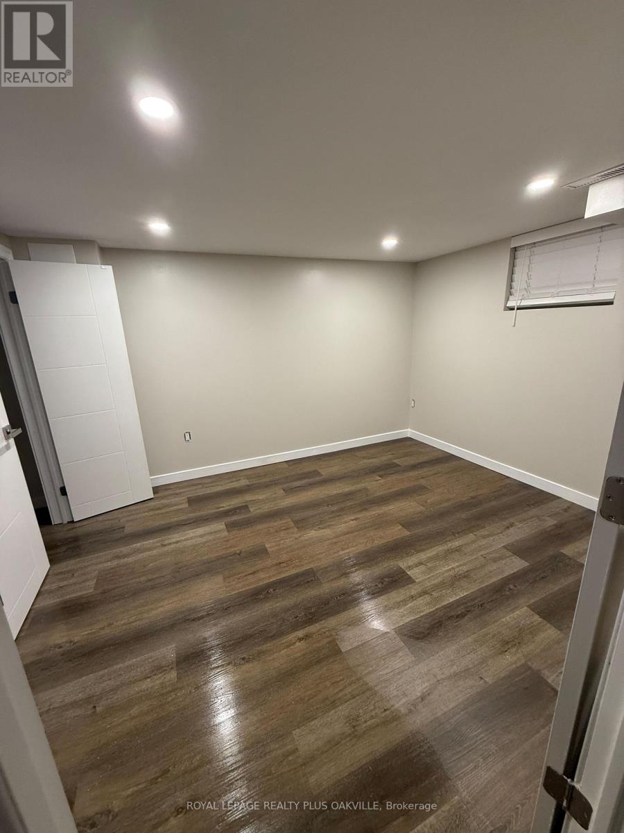 A room with wooden flooring and white walls.