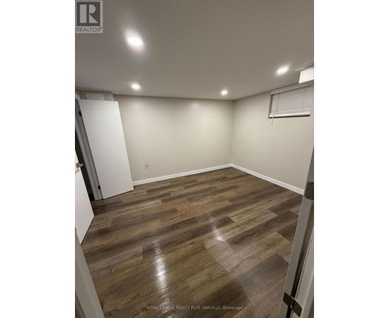 A room with wooden flooring and white walls.