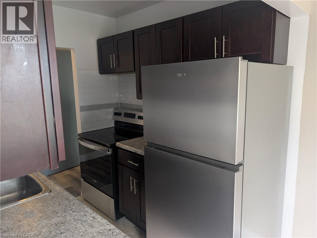 A kitchen with a stainless steel refrigerator and oven.
