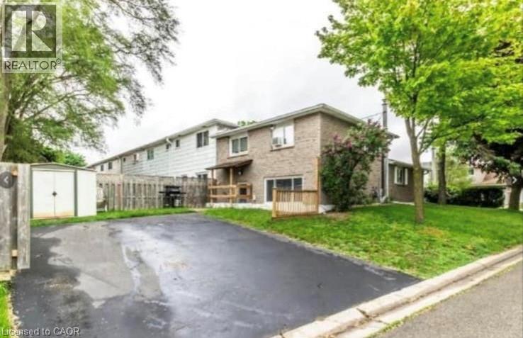 A realtor image of a residential area with a driveway and houses.