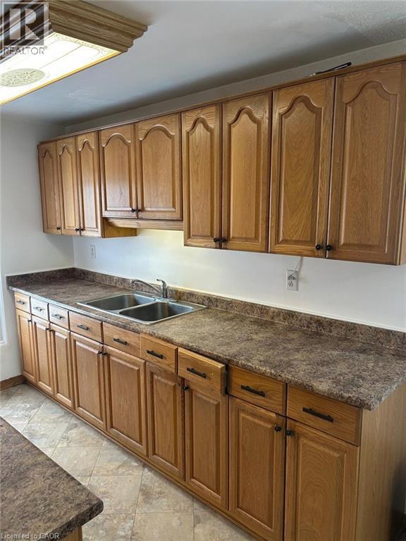 A kitchen with wooden cabinets and a granite countertop.