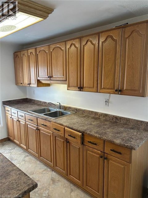A kitchen with wooden cabinets and a granite countertop.
