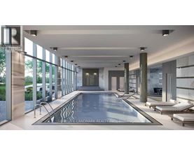 A large indoor swimming pool with a glass wall on one side.