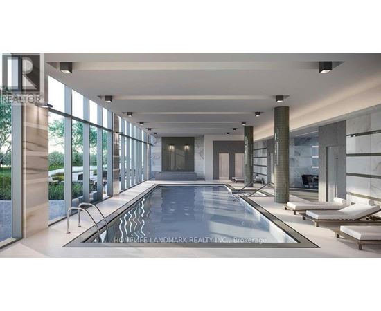 A large indoor swimming pool with a glass wall on one side.