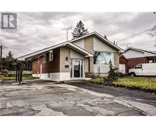 A house with a sign that says RE/MAX CROSSROADS REALTY INC Brokerage.