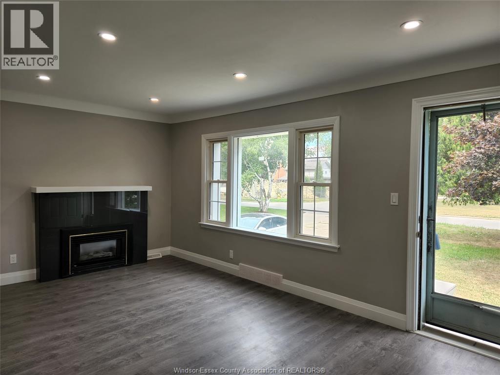 A room with a fireplace and sliding glass doors.