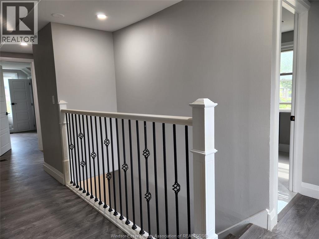 A black and white railing in a room with a REALTOR sign.
